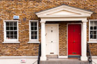 Dublin. Dzielnica Kilmainham. Biało-czerwone drzwi wejściowe do kamienicy. - foto: wnieznane.pl